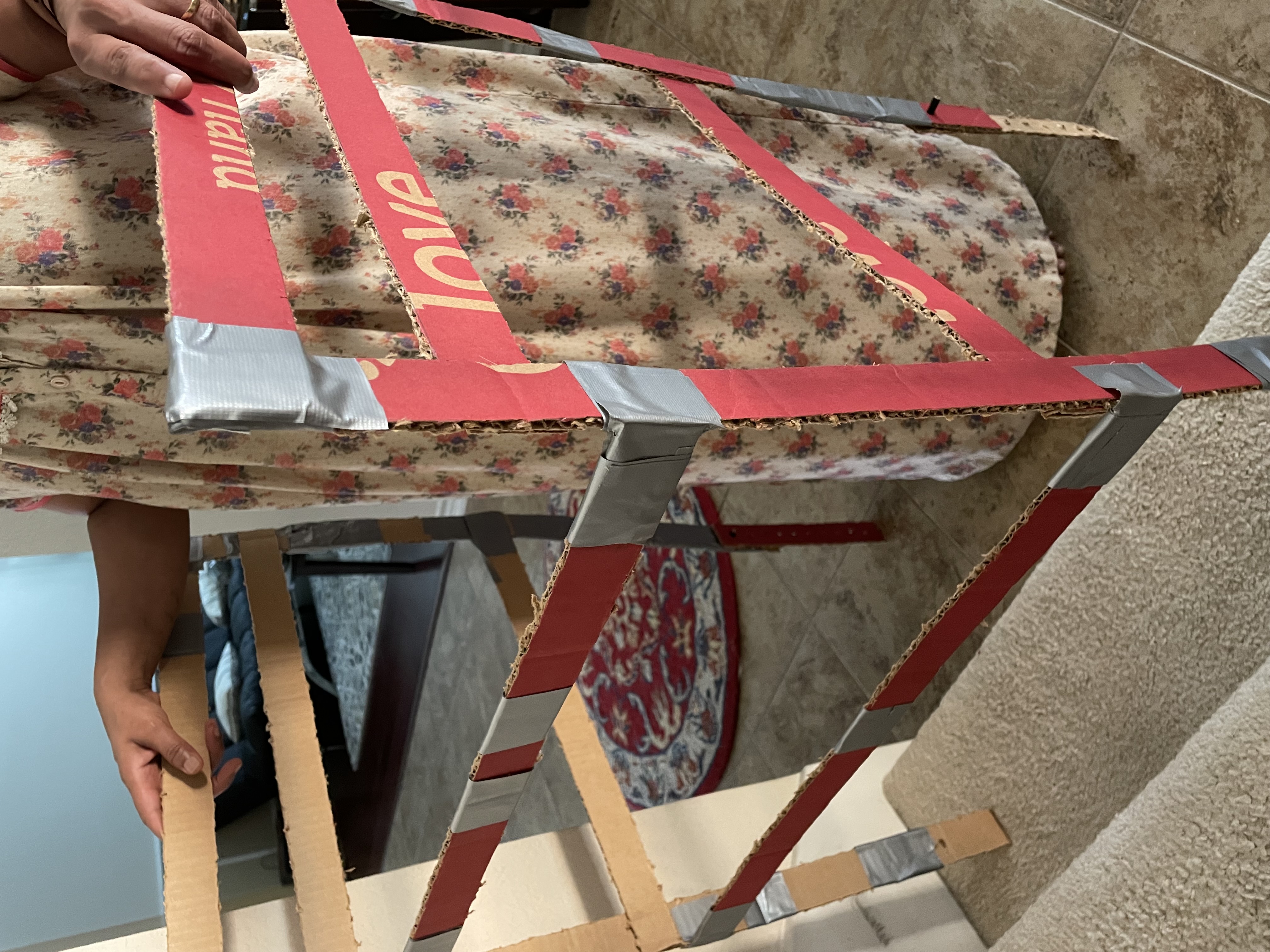 cardboard prototype walker being used to go up stairs